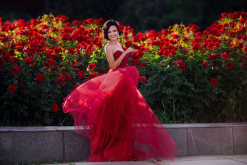 Beautiful girl wearing elegant dress posing near colorful flowers. Art work of romantic woman .