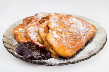 french toast with jam on black plate
