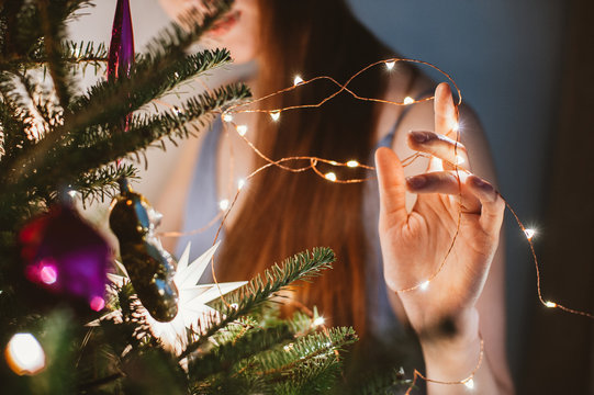 Woman decorates christmas tree