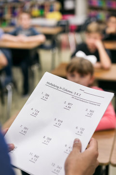 Classroom: Teacher Holds Copy Of Math Test