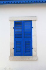 window with closed blue wooden shutters 