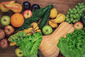 Various fresh vegetables and fruits on a wooden oak table