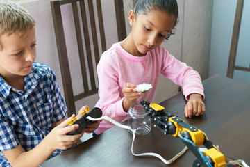 Kid's programming a robot