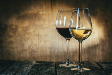 Fototapeta Red and white wine in glasses on rustic background, copy space obraz