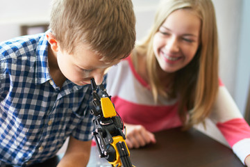 Silly kids: Remote controlled robot squeezing a nose
