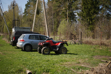 Parking at the cottage. Jeep , passenger car, quad bike, bicycles. © olga