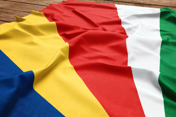 Flag of Seychelles on a wooden desk background. Silk Seychellois flag top view.