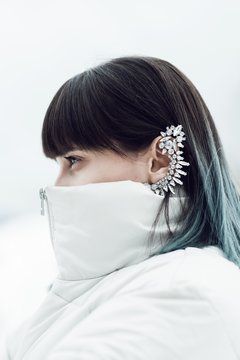 Portrait of a woman with blue hair and an earcuff