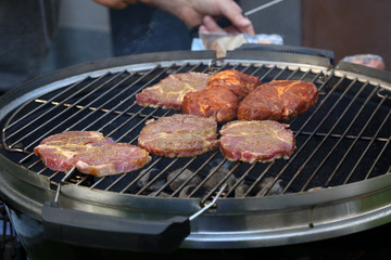 Meat and sausages are fried on the grill