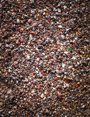 Sand and gravel on a seashore as nature background.