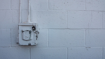 Electrical Breaker Box on White Cinder Block Wall