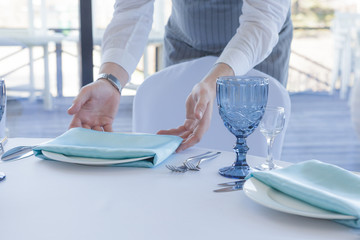 Restaurant waiter serves a table for a wedding celebration