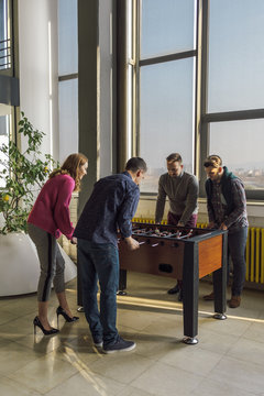 Co-Workers Playing Table Soccer At The Office