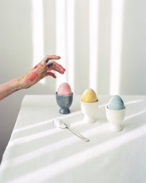 Hand in paint and Easter eggs