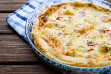 Rustic large tart with cloth on a wooden table, view from above, close-up