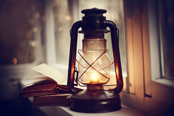 Kerosene lamp and old books