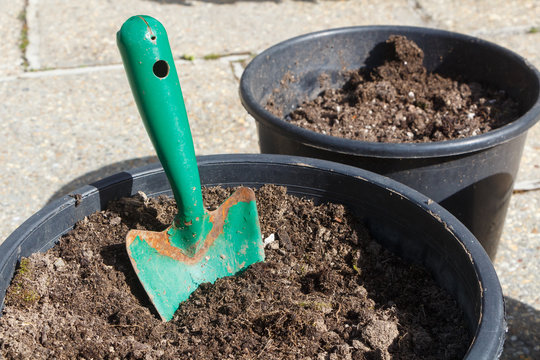 Flowerpot with loam and gardening trowel before planting flowers