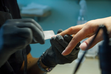 Hardware manicure in modern beauty salon. Procedure for the preparation of nails