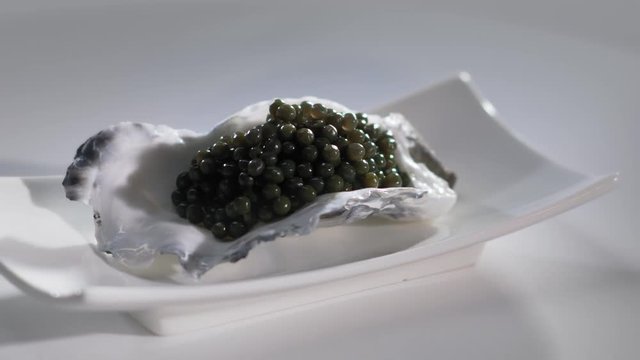 Black Caviar in Oyster Shell Seafood High quality natural sturgeon black caviar close-up, Expensive. 