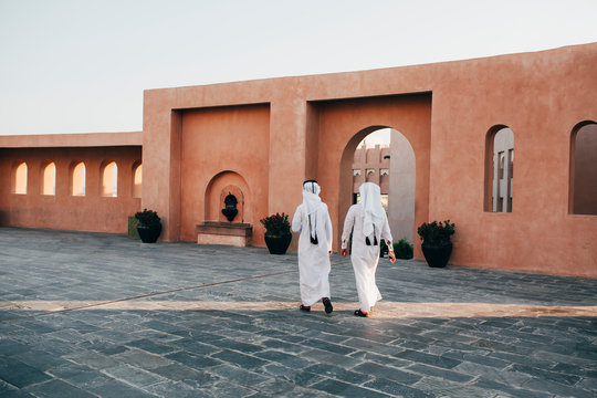 Men wearing long white abayas in Doha