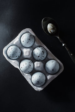 Painted eggs in rack and spoon