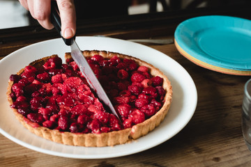 Anonymous woman cutting a mixed berry pie