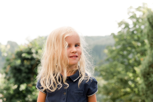 little blonde girl with blue shirt and dimple