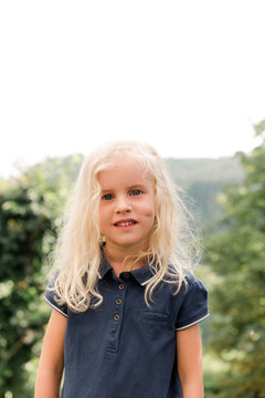 little blonde girl with blue shirt and dimple