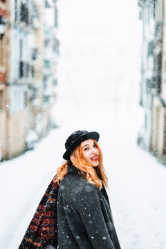 potyrait of a woman in a snowy city landscape