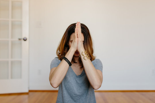 Beautiful woman practicing meditation at home