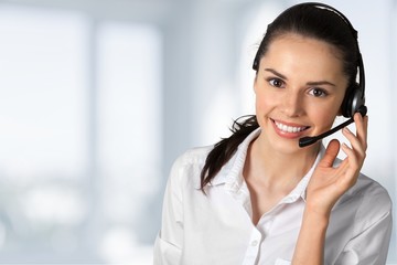 Close-up view of young woman face with headphones, call center or support concept
