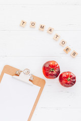 Tomatoes Mar Azul on white wooden table background