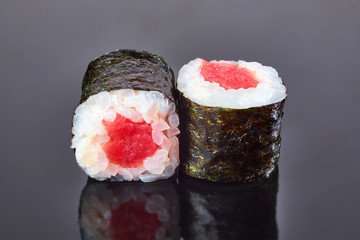 Classical roll sushi with tuna on black background for menu. Japanese food