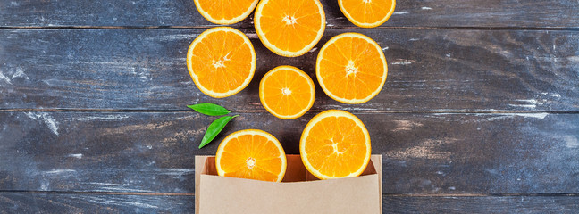 Fresh oranges on dark wooden background