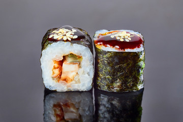 Classical roll sushi with smoked eel on black background for menu. Japanese food