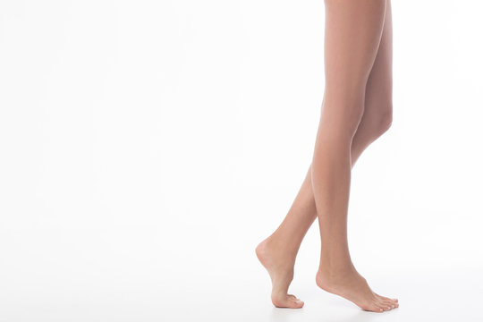 Full length of long female legs isolated on white background.