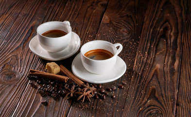 Two cups of espresso coffee on wooden table