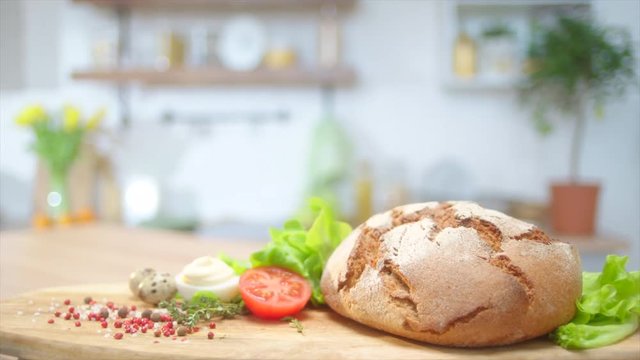 Commercial packshot with home baked bread and fresh greens at the table