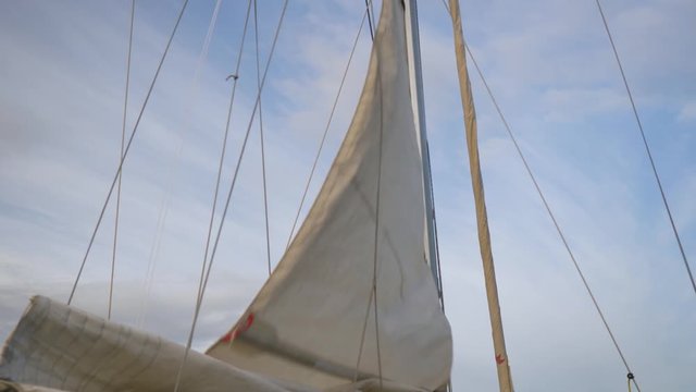 Sail being hoisted on sailing training yacht