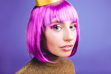 Closeup portrait amazing fashionable young woman with cut purple hair on violet background....