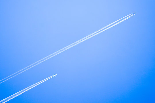 Two Planes Flying High In The Sky, Leaving White Streaks