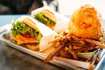 Delicious New York fast food menu. Burger, chips and onion rings.