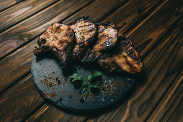 Pork bone steak on a wooden background with honey. Board slate. kenza, pepper