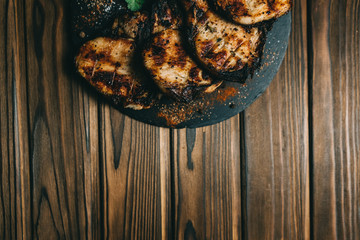 Pork bone steak on a wooden background with honey. Board slate. kenza, pepper