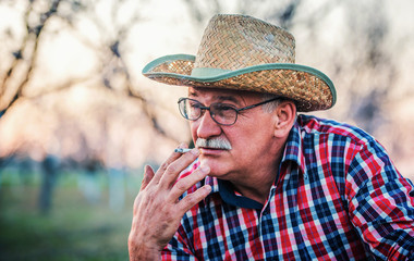 Senior man smoking cigarette