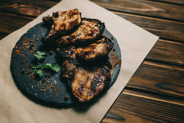 Pork bone steak on a wooden background with honey. Board slate. kenza, pepper