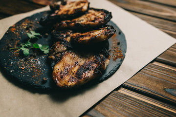 Pork bone steak on a wooden background with honey. Board slate. kenza, pepper