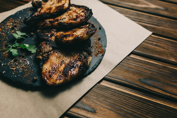 Pork bone steak on a wooden background with honey. Board slate. kenza, pepper