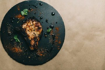 Pork bone steak on a wooden background with honey. Board slate. kenza, pepper