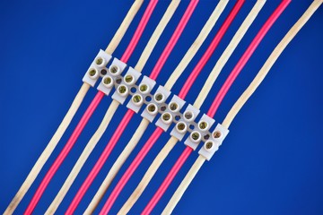 Electrical wires are connected by clamping terminals. Wiring for power supply and data transmission...